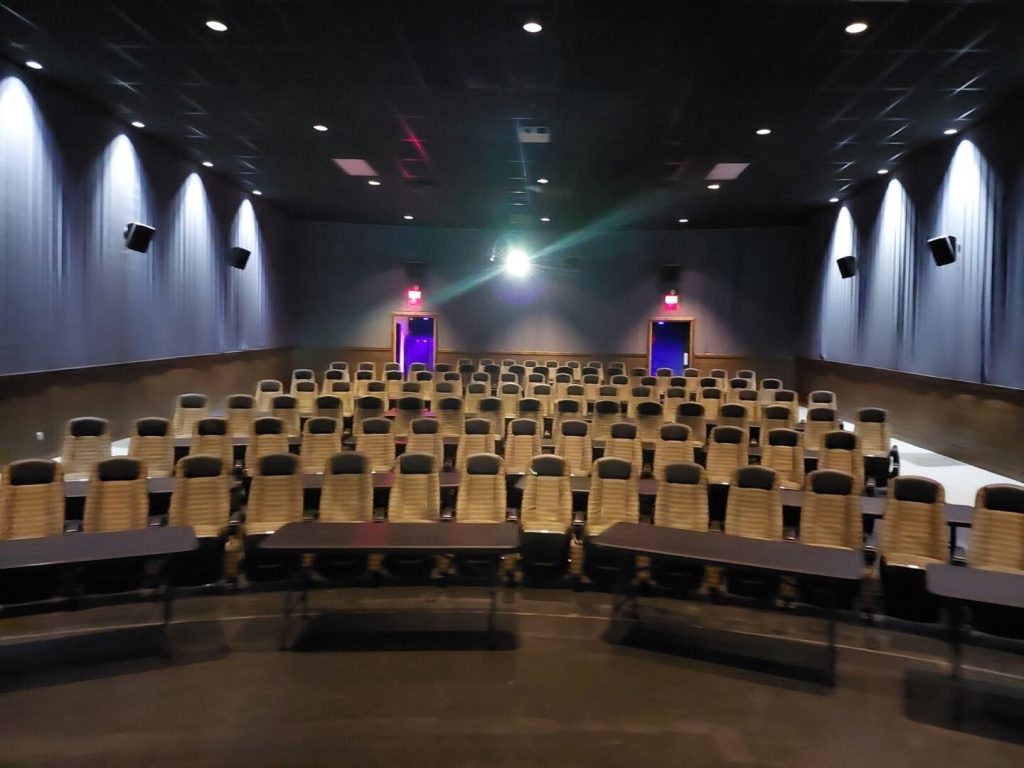 blurry pic of Mariner Theatre in Marinette Wisconsin. Locally Owned Movie Theater. View of the new luxury high back seats with tables in between each row, and 5 feet of space between the rows